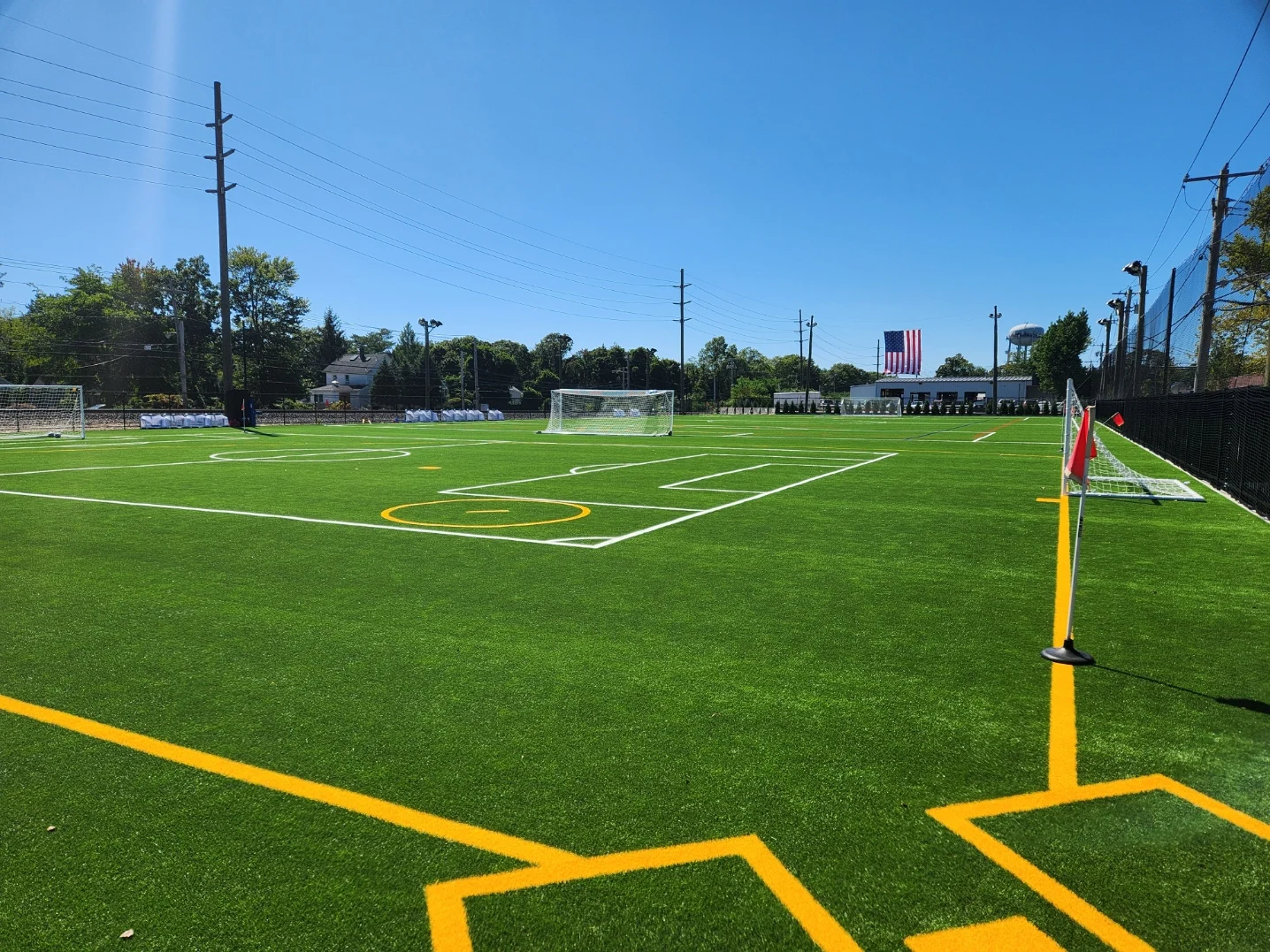 The smaller soccer field in the foreground, with the larger club field beyond it.